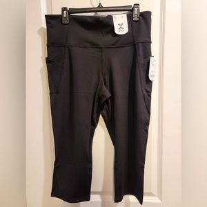 Black workout set with capri leggings and sports bra. Never worn.